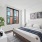 bedroom with large window and dresser