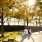 men sit on steps talking in park area as people pass by
